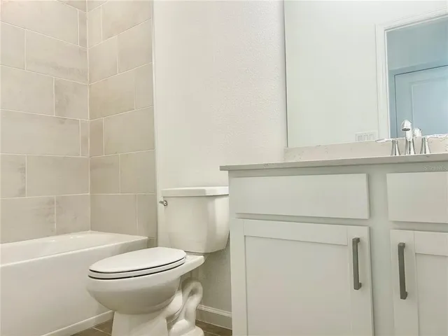 a bathroom with a toilet a sink and shower