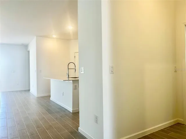 a view of a sink and dishwasher with wooden floor