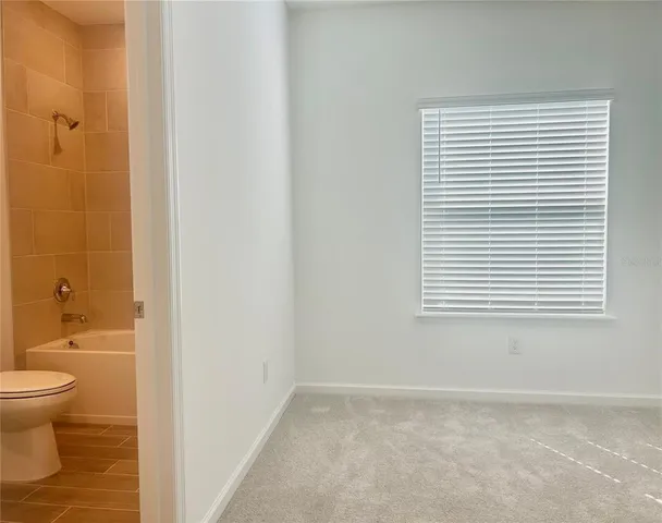 a bathroom with a toilet a sink and a window