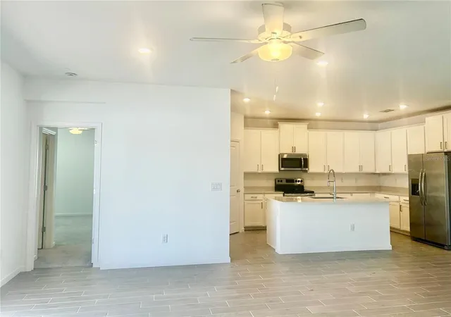 a kitchen with stainless steel appliances a stove a refrigerator and a refrigerator