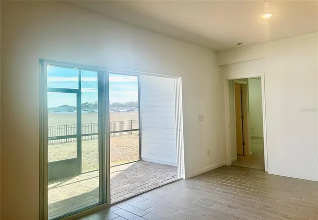 a view of an empty room with glass door