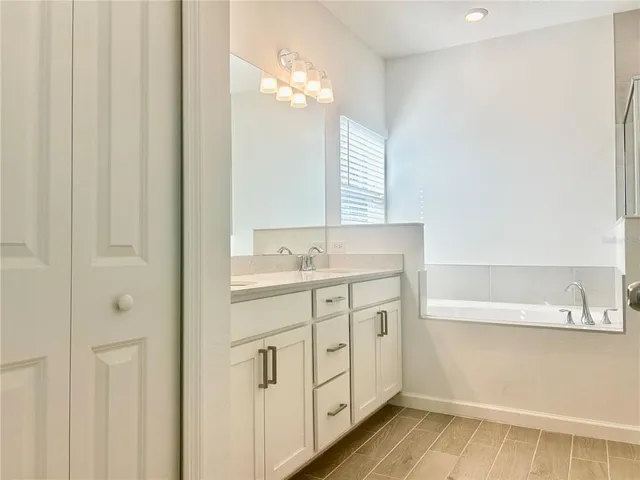 a bathroom with a sink a mirror and a shower