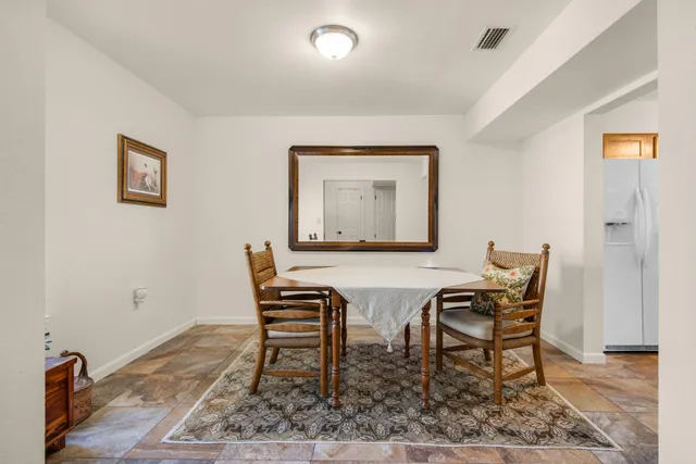 a dining room with furniture and wooden floor