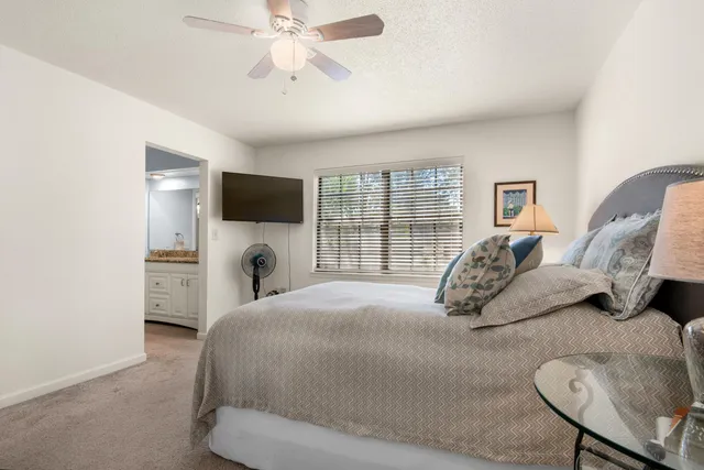 a bathroom with a granite countertop sink a mirror a vanity and a bathtub