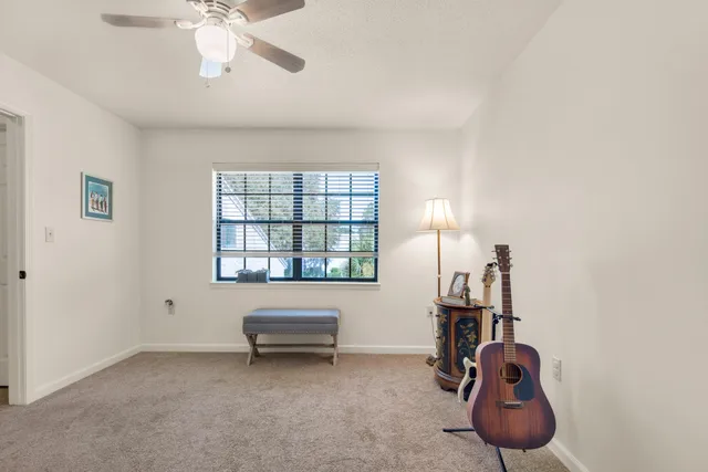 a view of a livingroom with furniture and a ceiling fan
