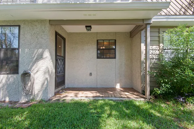 a backyard of a house with palm trees