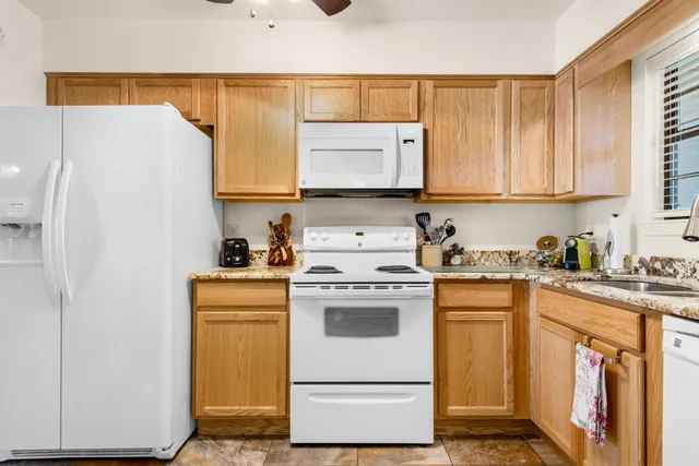 a kitchen with a sink a stove and a refrigerator