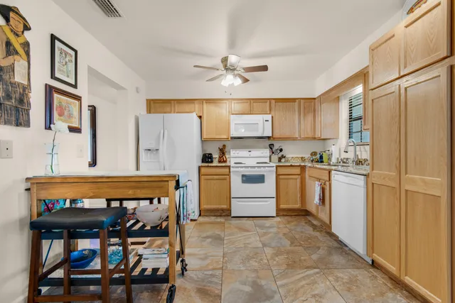 a kitchen with a stove a refrigerator and a dining table