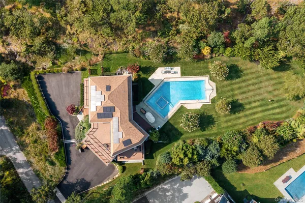 an aerial view of a house with a yard