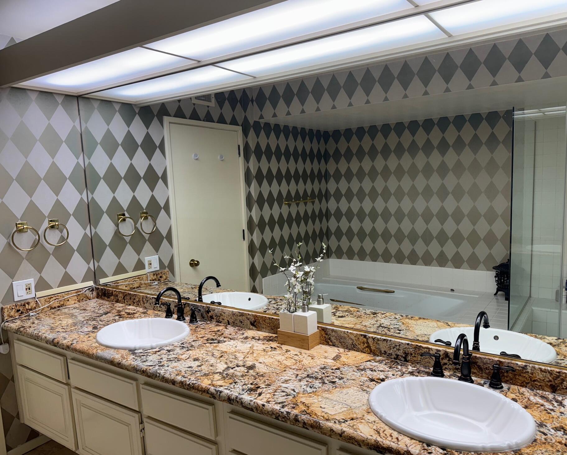 222 Monterey Road, Unit 306 Glendale, CA 91206 - Photo 12 of 32 a bathroom with a granite countertop sink and a mirror