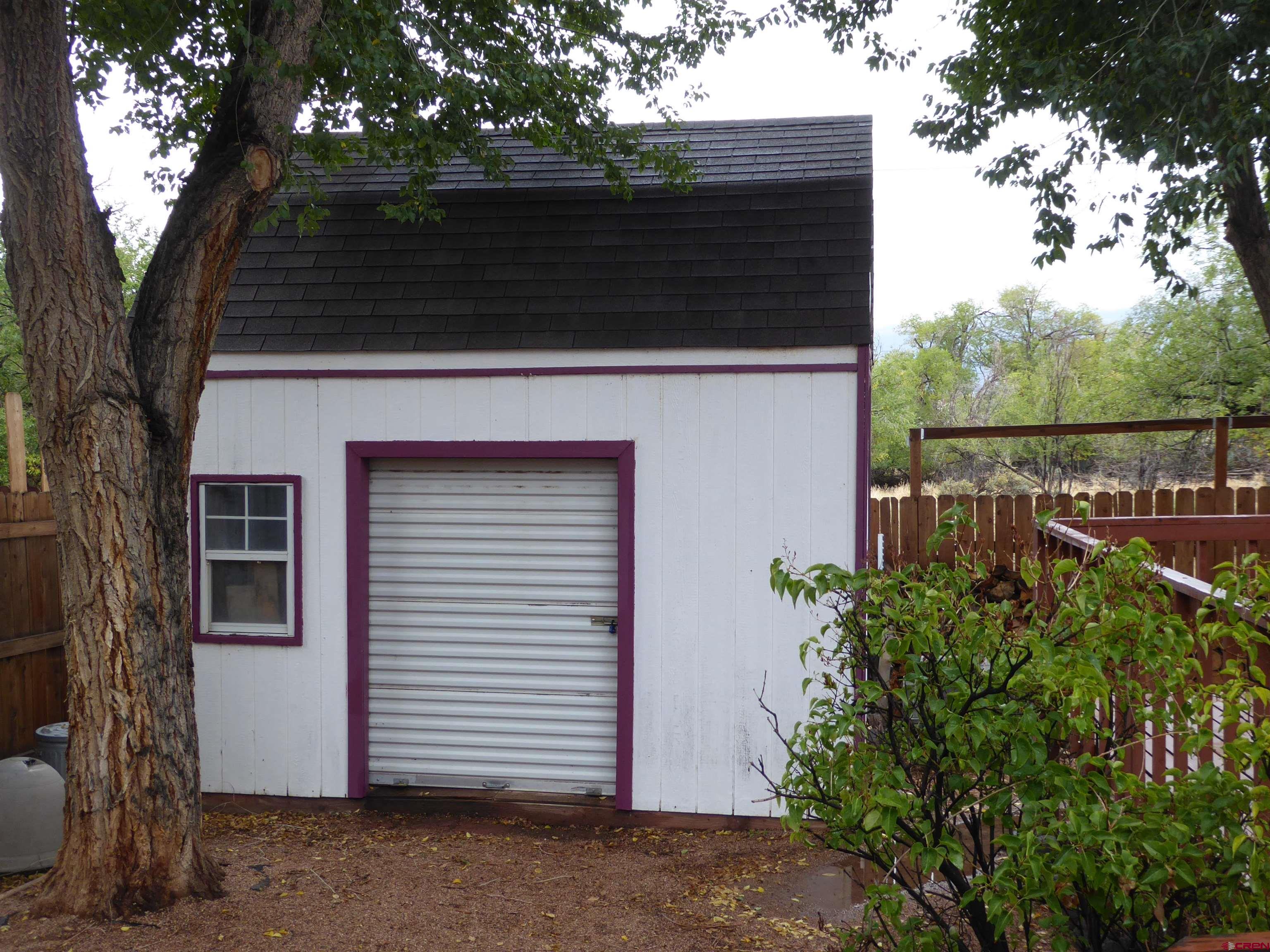 180 Northwest 7th Street Cedaredge, CO 81413 - Photo 12 of 44 a side view of a house with a tree