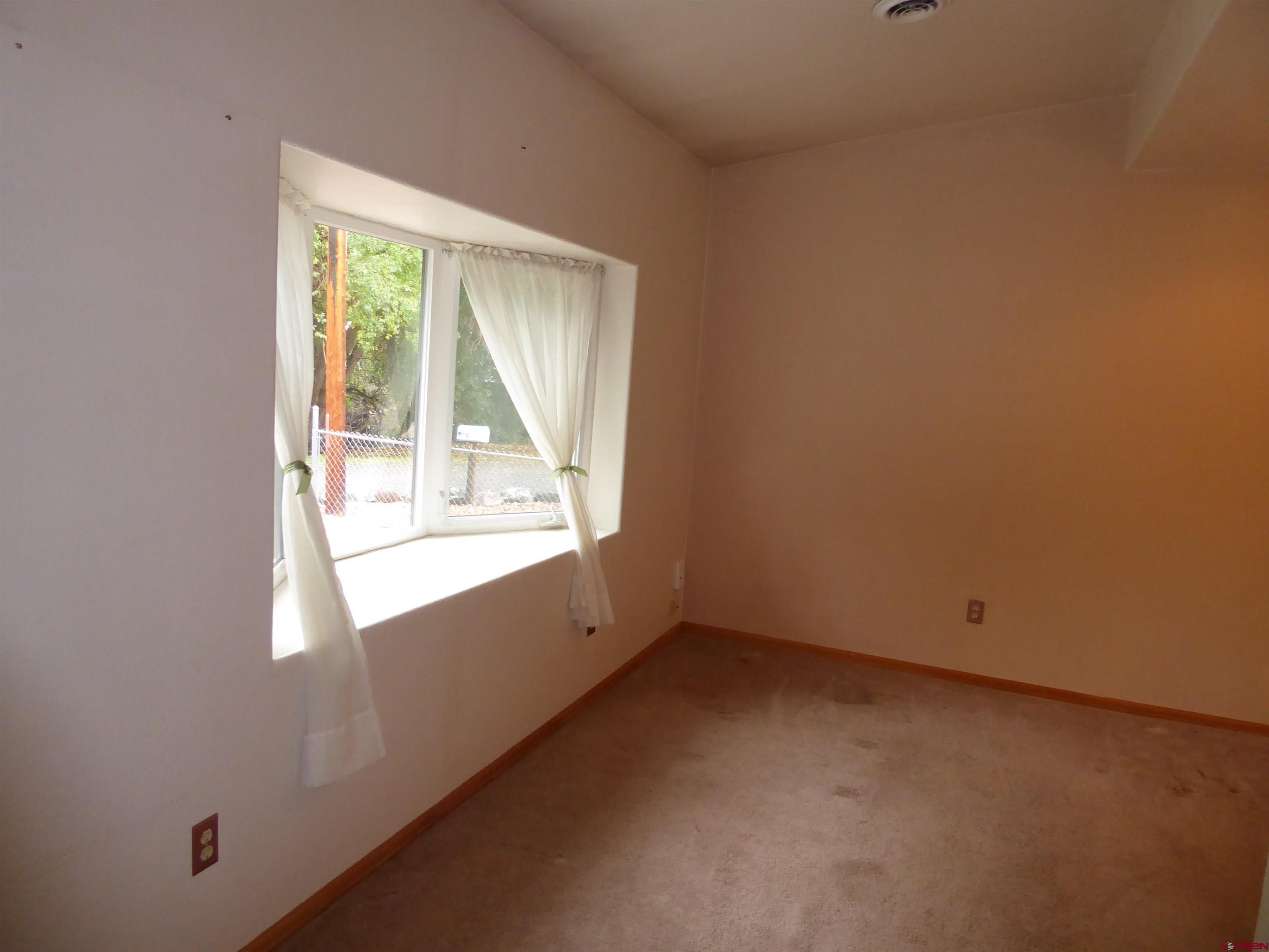 180 Northwest 7th Street Cedaredge, CO 81413 - Photo 13 of 44 an empty room with a window