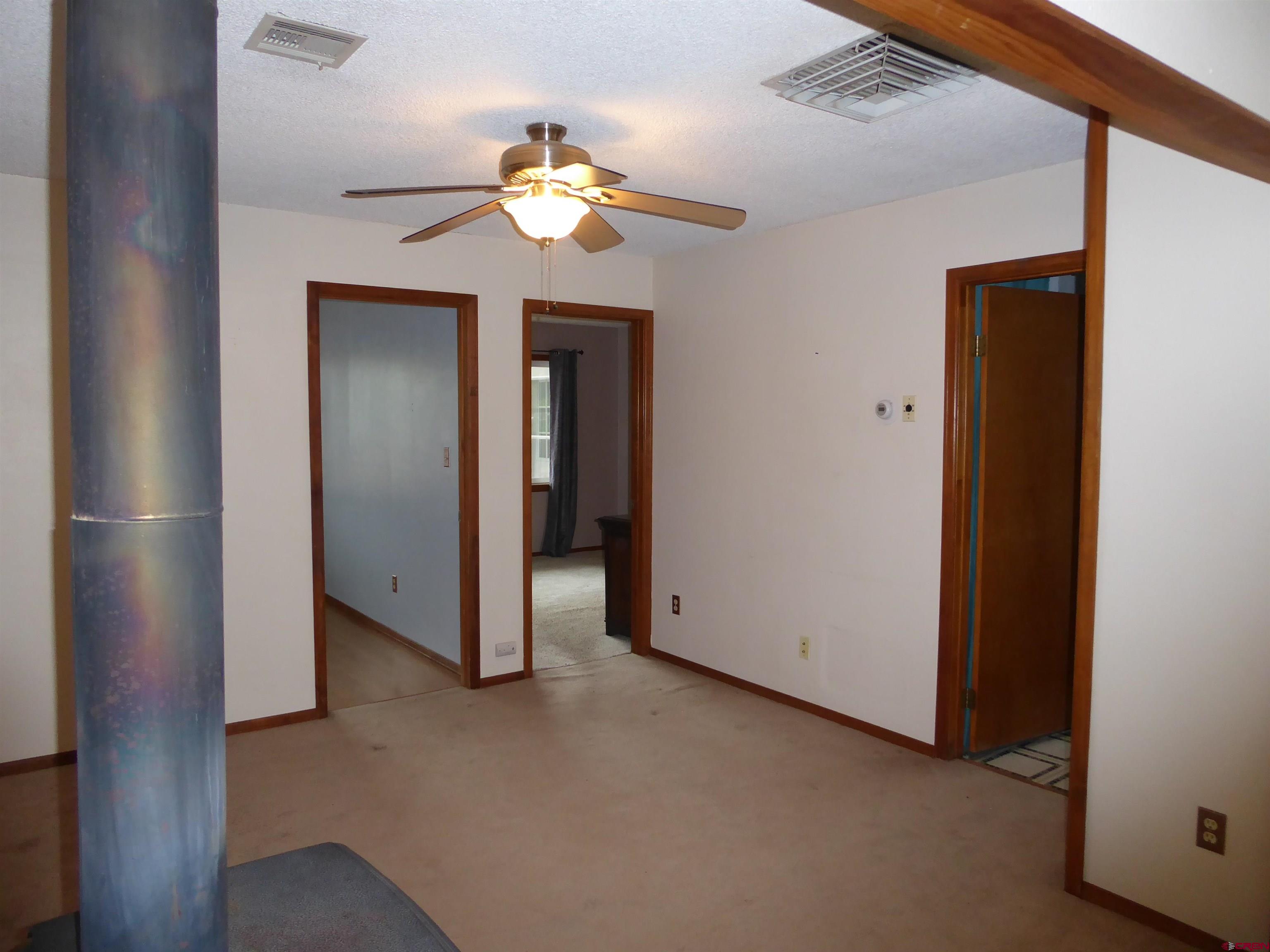 180 Northwest 7th Street Cedaredge, CO 81413 - Photo 19 of 44 a view of an empty room with wooden floor