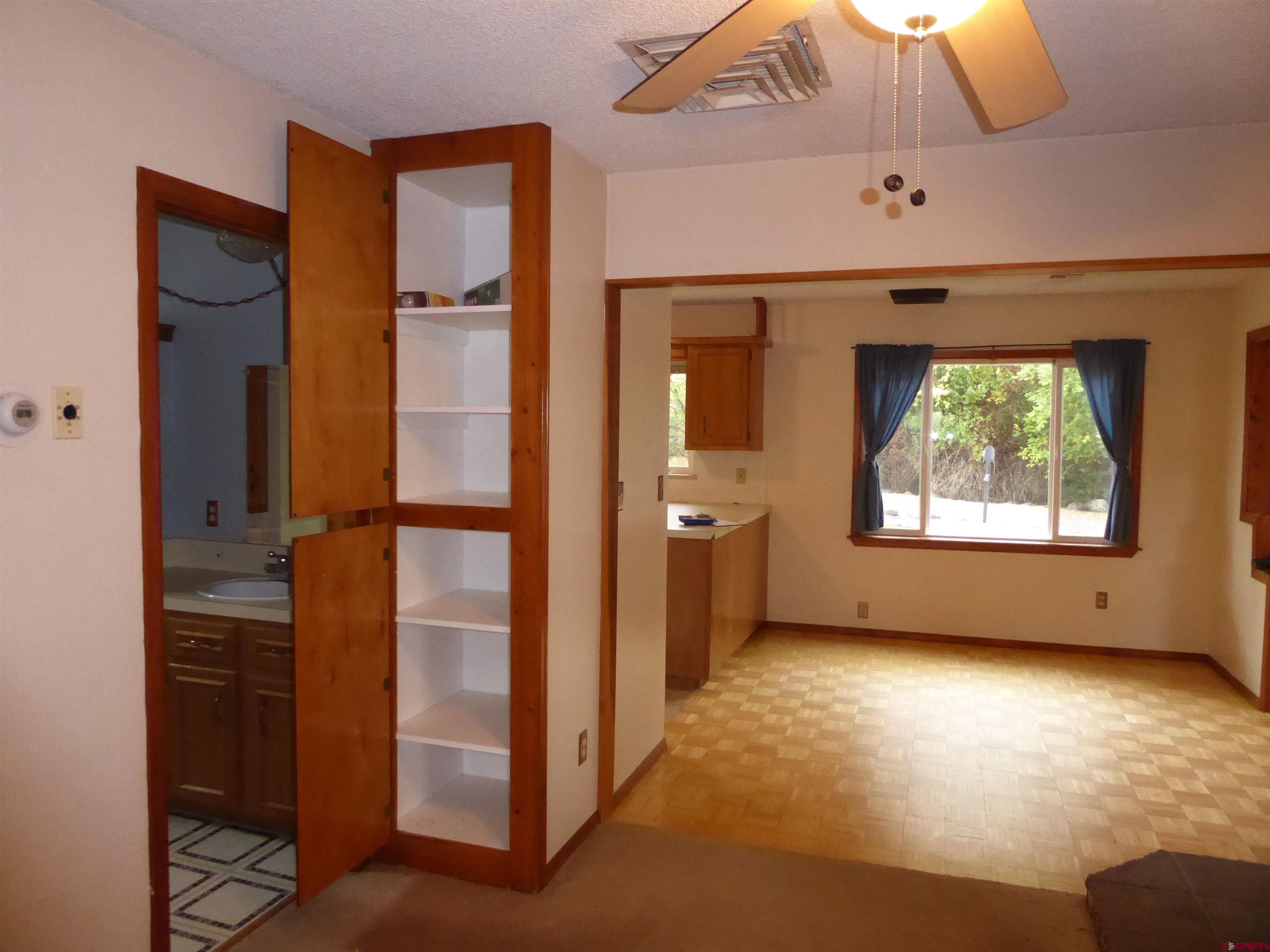180 Northwest 7th Street Cedaredge, CO 81413 - Photo 22 of 44 wooden floor in an empty room with a window