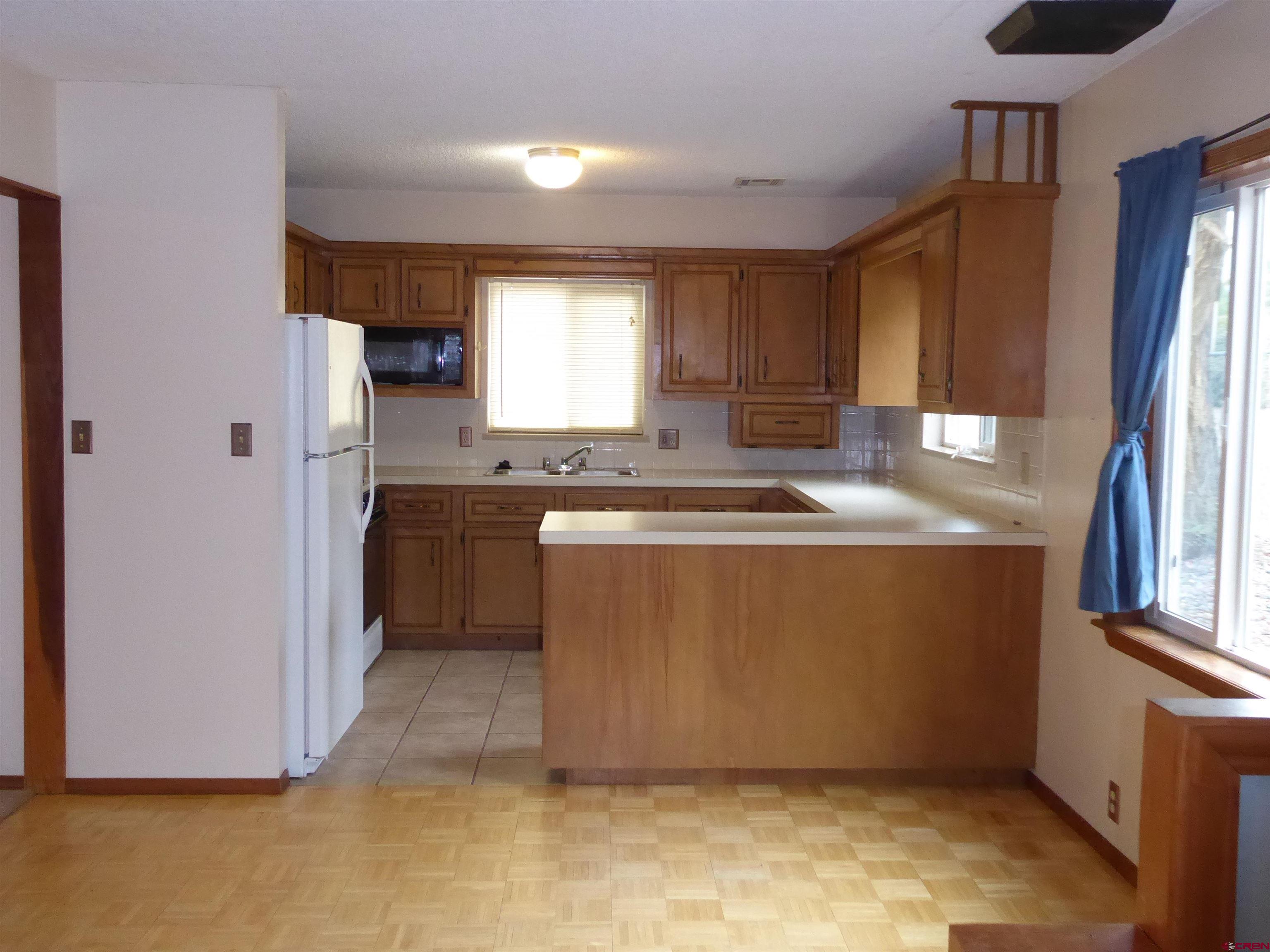 180 Northwest 7th Street Cedaredge, CO 81413 - Photo 24 of 44 a room with kitchen island a sink a window and cabinets