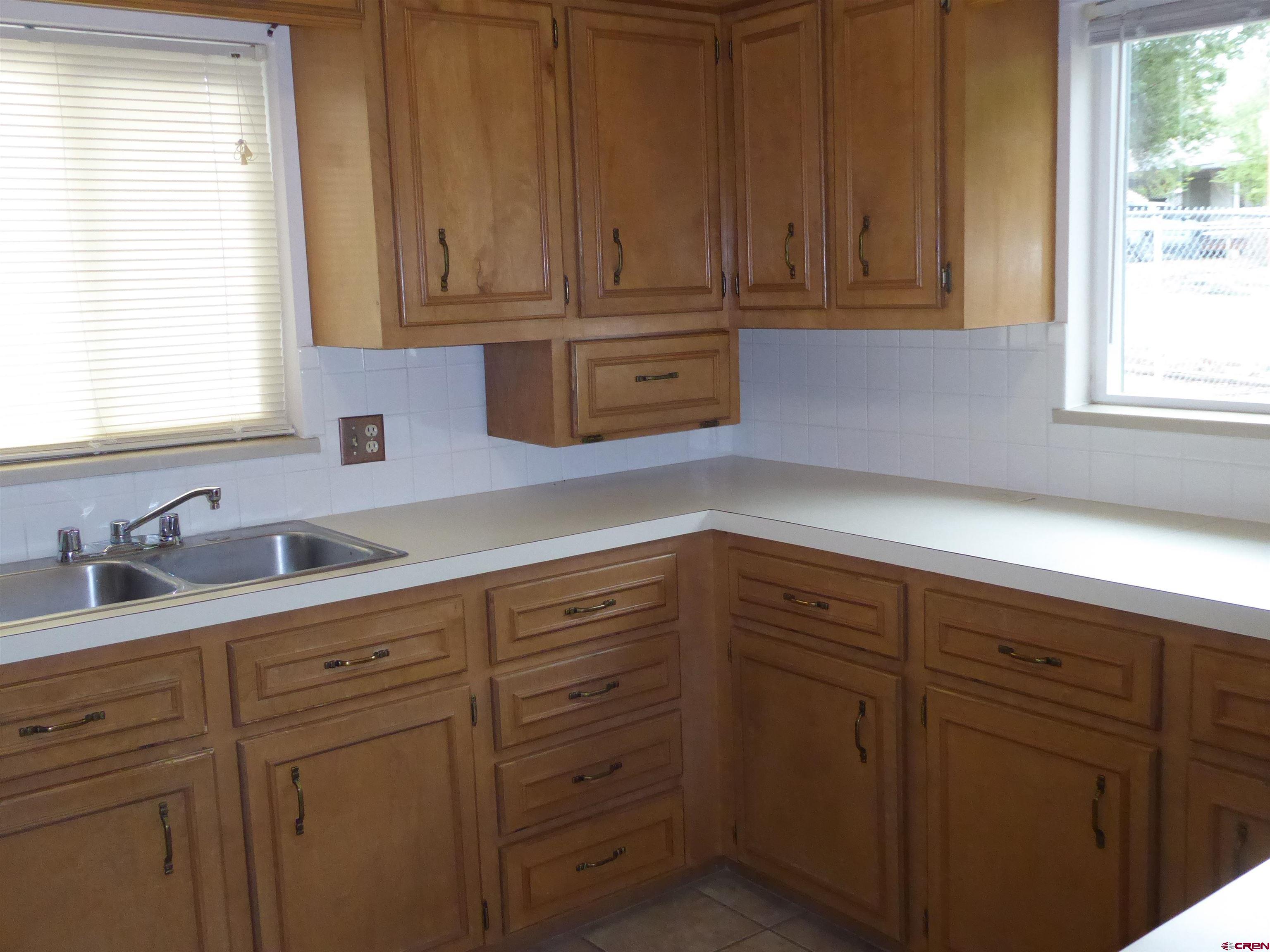 180 Northwest 7th Street Cedaredge, CO 81413 - Photo 29 of 44 a kitchen with cabinets appliances and a window