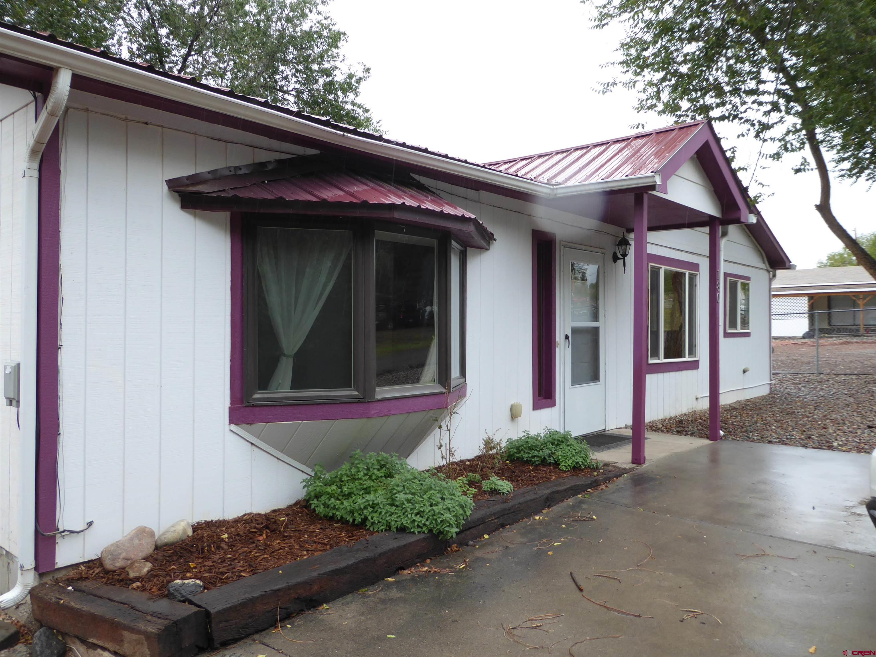 180 Northwest 7th Street Cedaredge, CO 81413 - Photo 3 of 44 a front view of a house with a yard