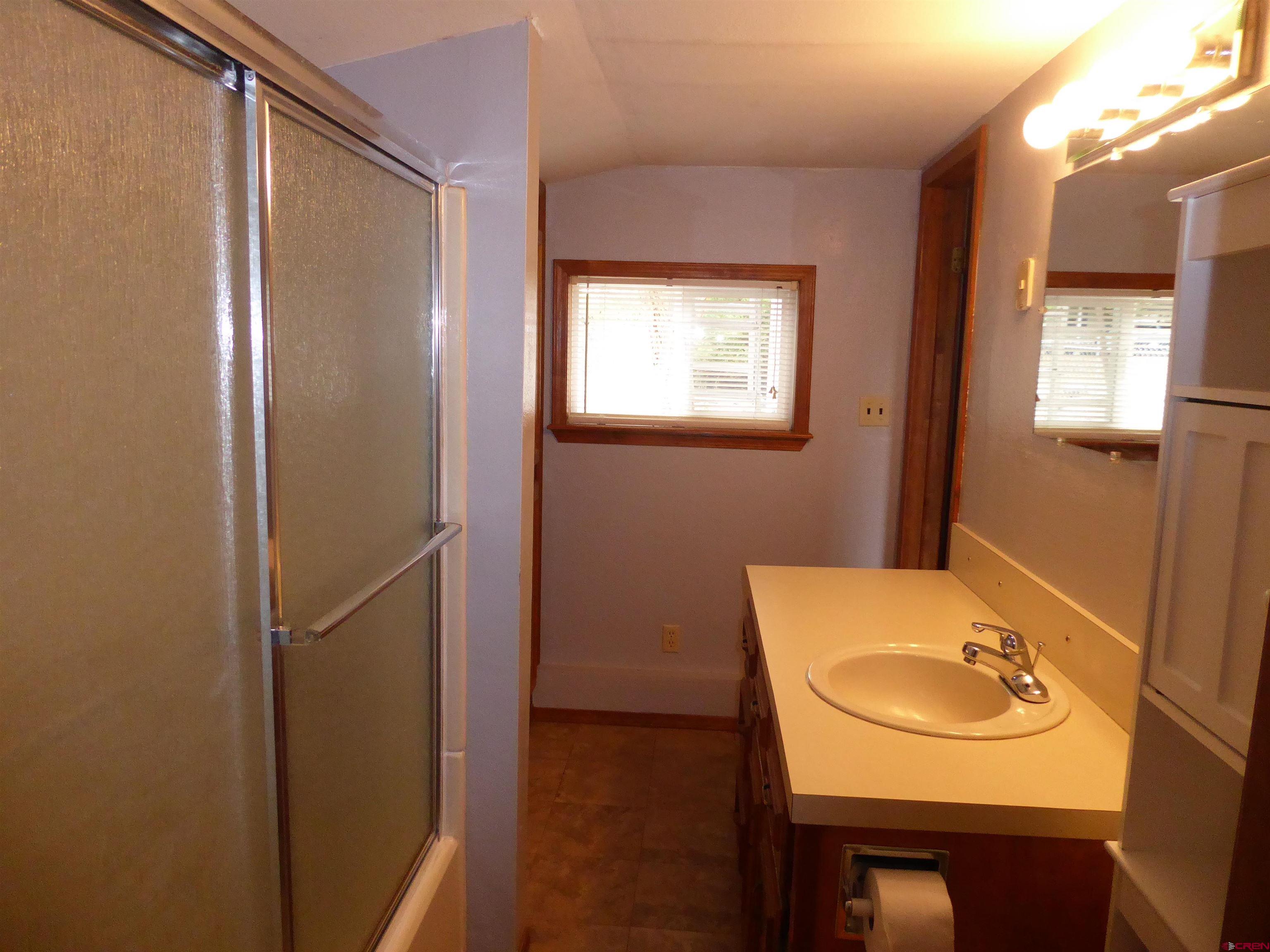 180 Northwest 7th Street Cedaredge, CO 81413 - Photo 33 of 44 a bathroom with a sink and a mirror