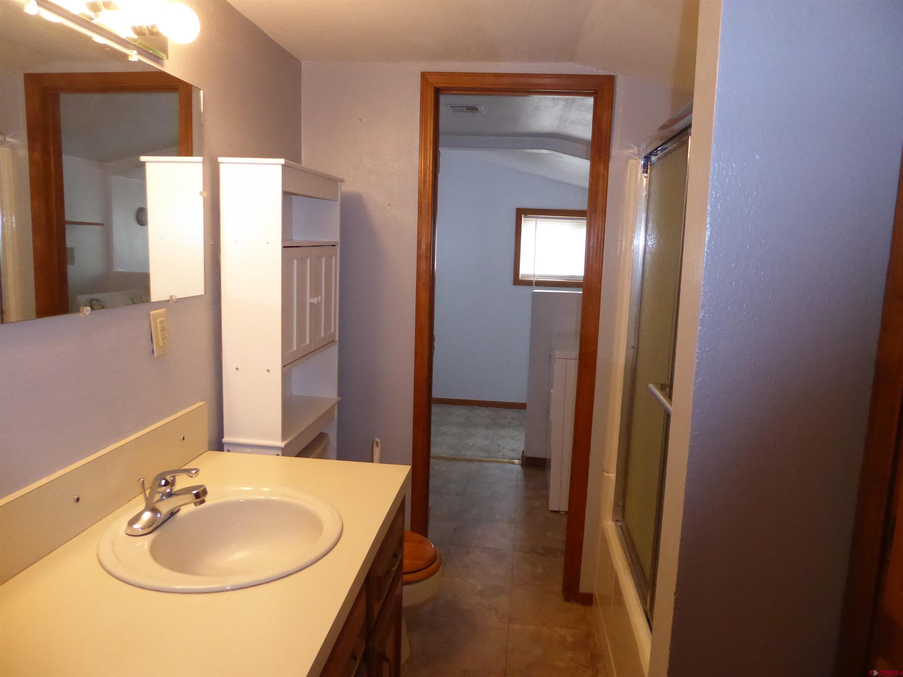 180 Northwest 7th Street Cedaredge, CO 81413 - Photo 35 of 44 a bathroom with a sink and a mirror