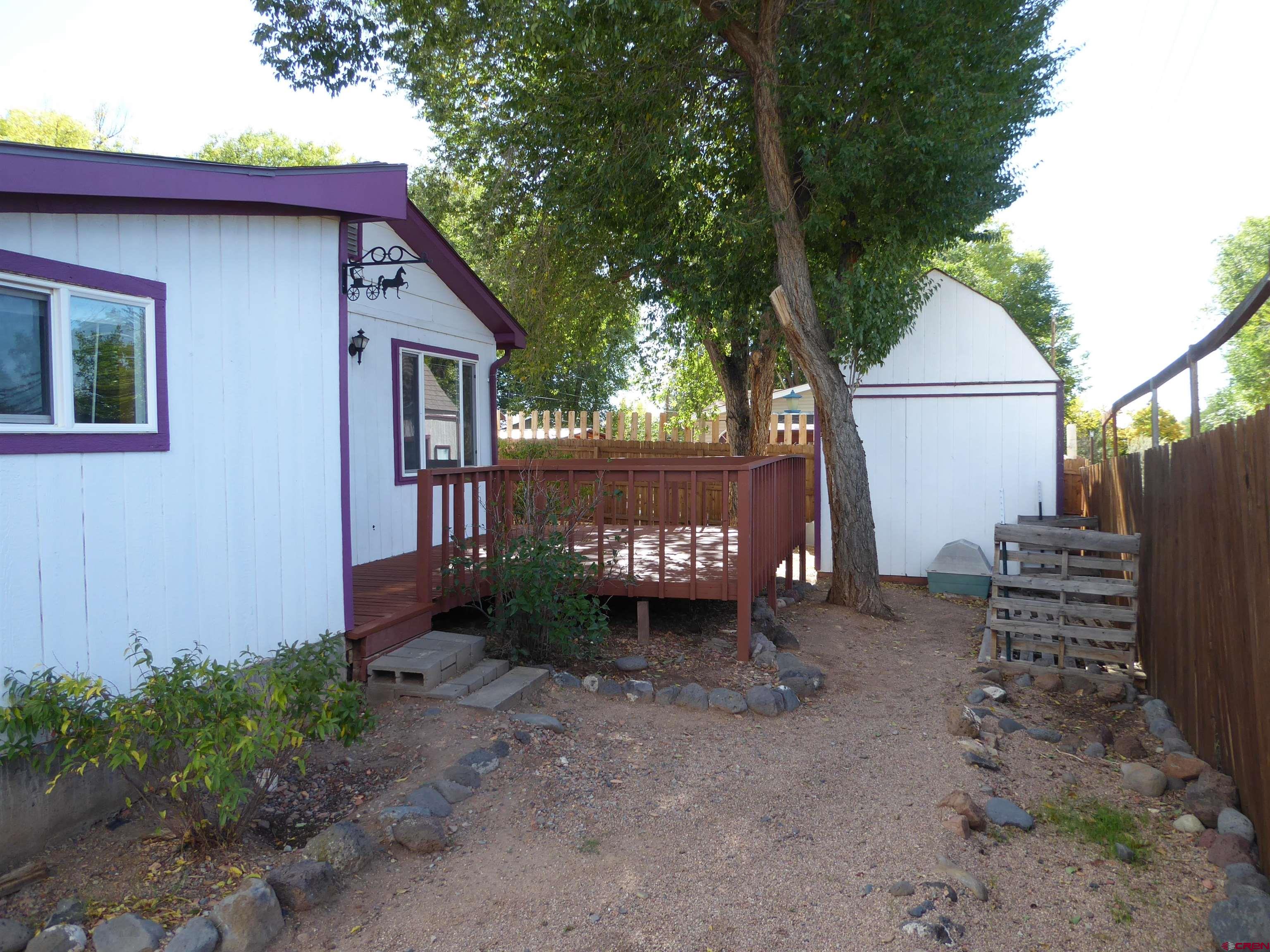 180 Northwest 7th Street Cedaredge, CO 81413 - Photo 10 of 44 a view of a house with a yard and sitting area