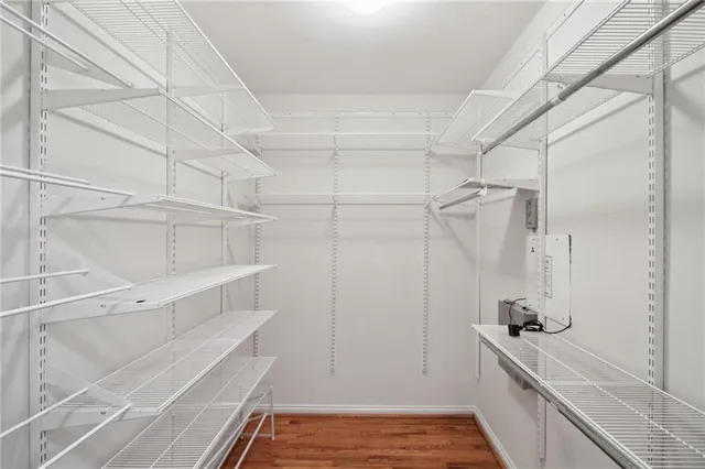 a bedroom with a bed a chandelier and a window