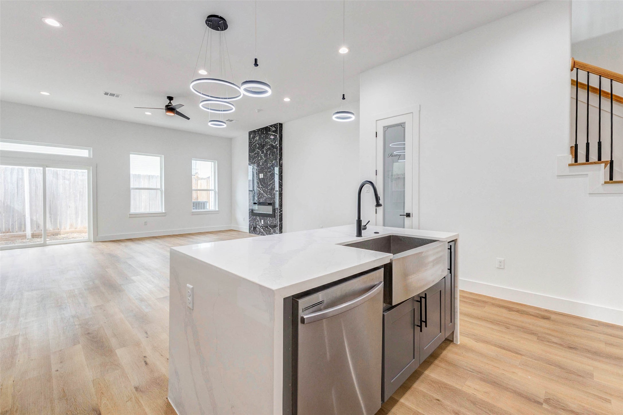 2118 Live Oak Street, Unit B Houston, TX 77003 - Photo 11 of 50 A bright, open main living area with a spacious island and modern lighting that draws the eye without overwhelming the space. Clean lines, warm floors, and an easy flow make it feel comfortable and well put together.