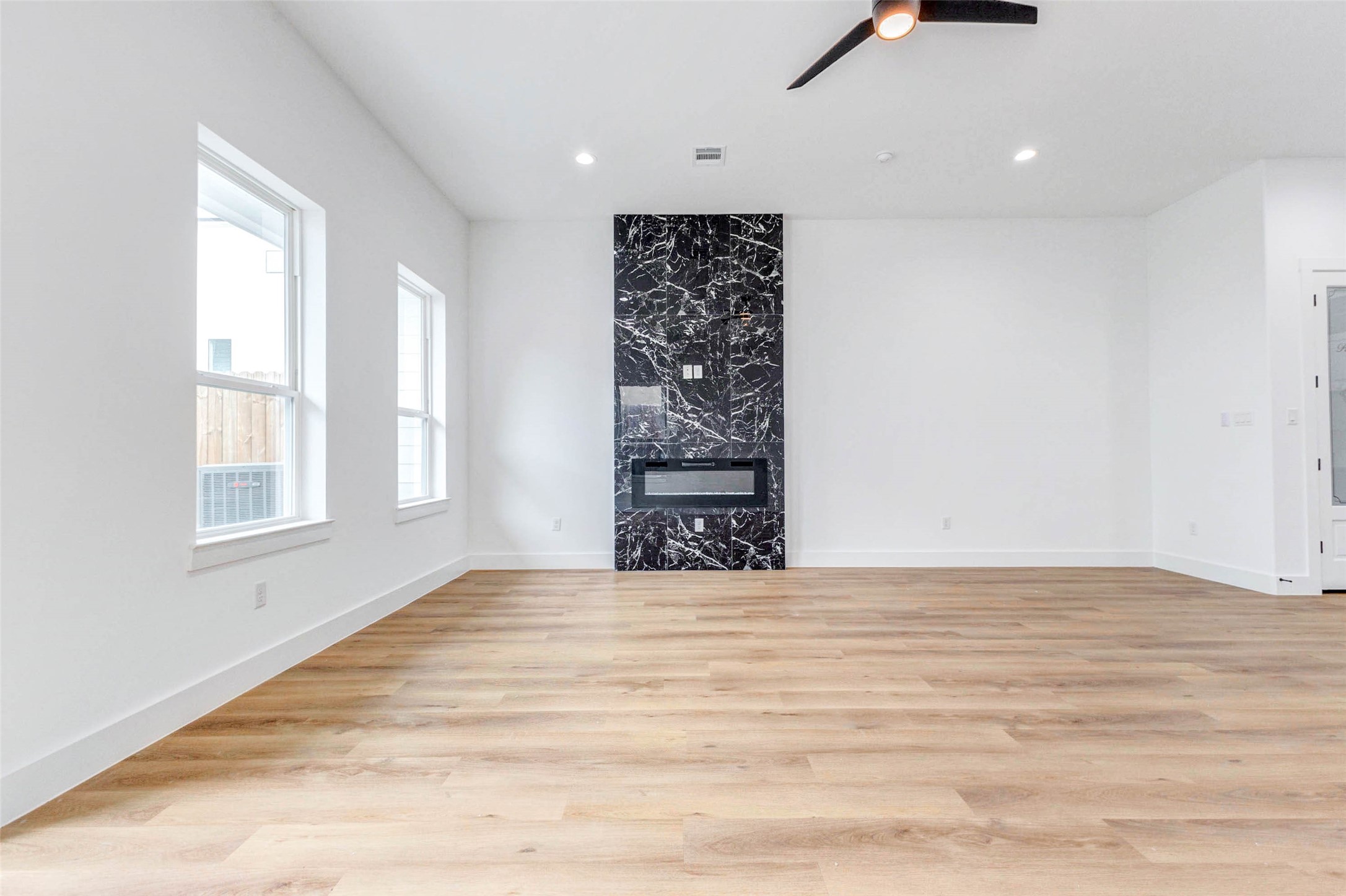 2118 Live Oak Street, Unit B Houston, TX 77003 - Photo 15 of 50 The bold fireplace adds a touch of character while keeping the room simple, open, and easy to arrange.