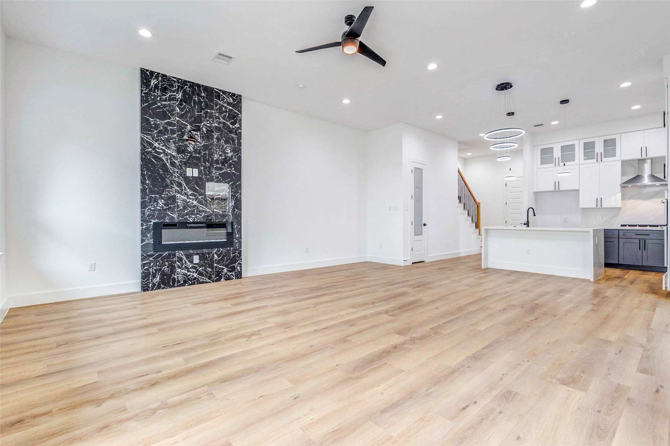 2118 Live Oak Street, Unit B Houston, TX 77003 - Photo 16 of 50 A bright, open living area with clean lines and plenty of natural light. The modern fireplace adds a strong focal point while the open layout connects easily to the kitchen for a relaxed, everyday flow.
