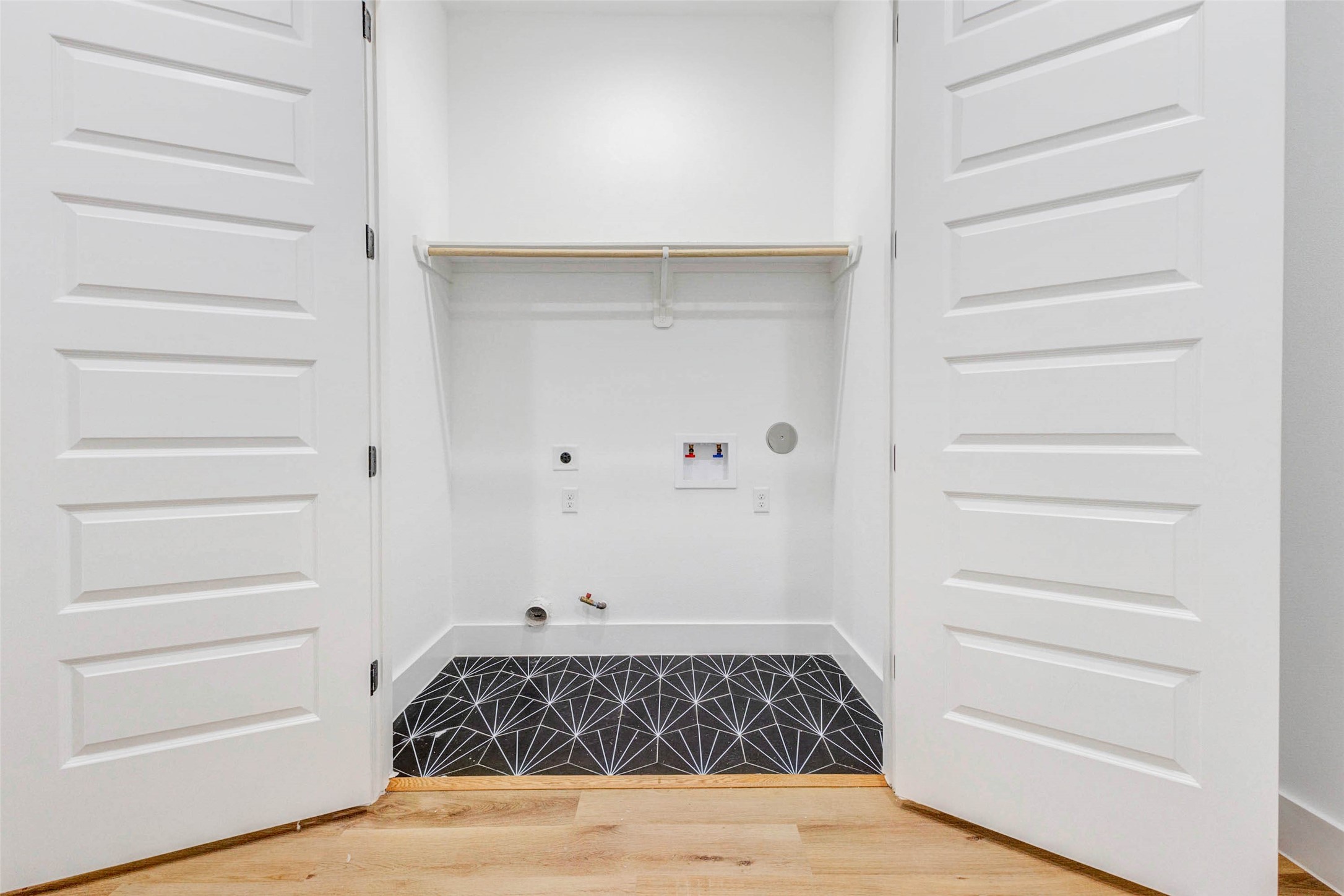 2118 Live Oak Street, Unit B Houston, TX 77003 - Photo 21 of 50 A dedicated laundry space tucked neatly behind double doors for a clean, organized look. Simple and functional, it keeps everyday tasks out of sight while staying easy to access.
