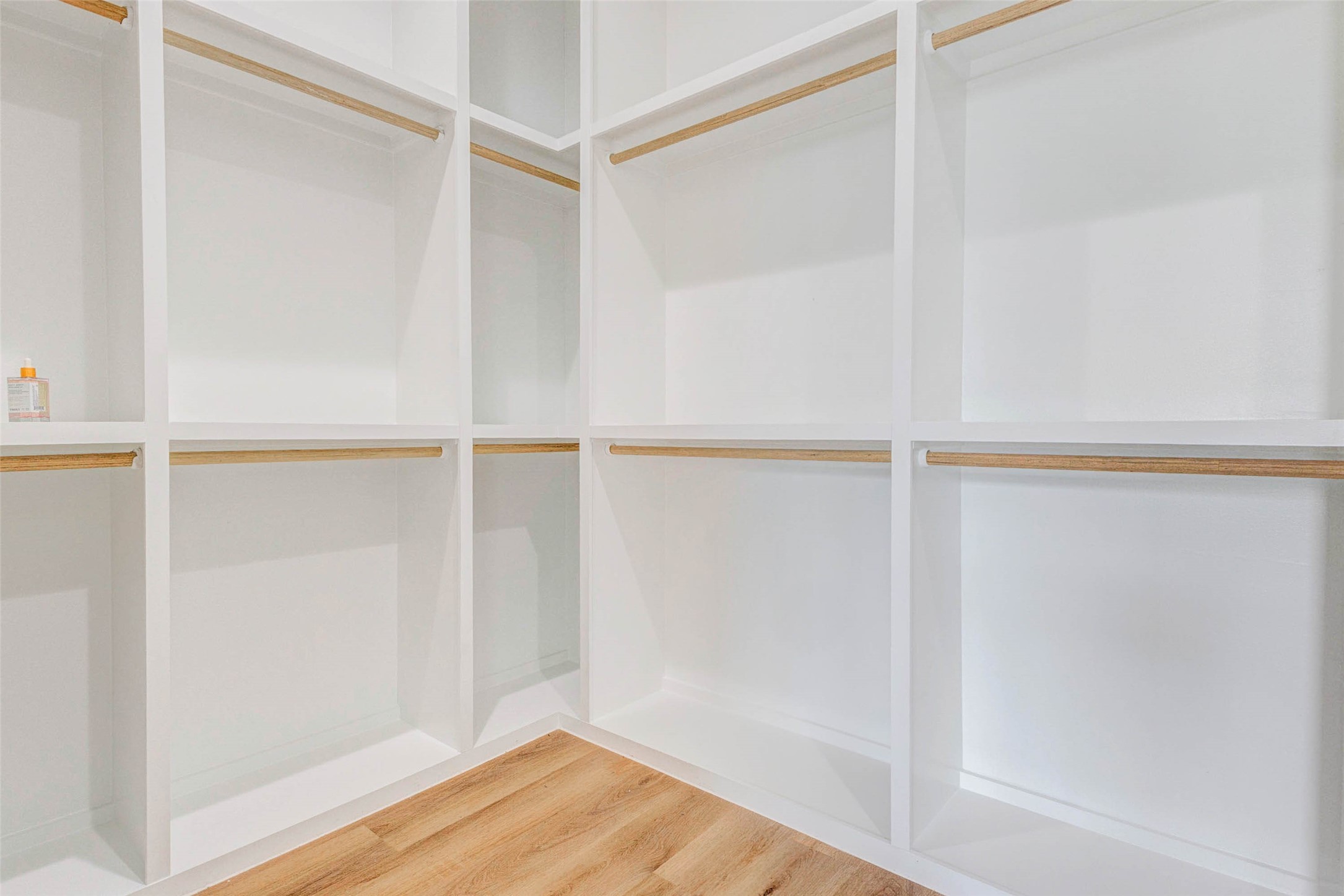 2118 Live Oak Street, Unit B Houston, TX 77003 - Photo 39 of 50 A spacious walk-in closet with a clean, built-out layout designed for easy organization. Open shelving and hanging space provide a simple, functional setup that keeps everything neat and accessible.