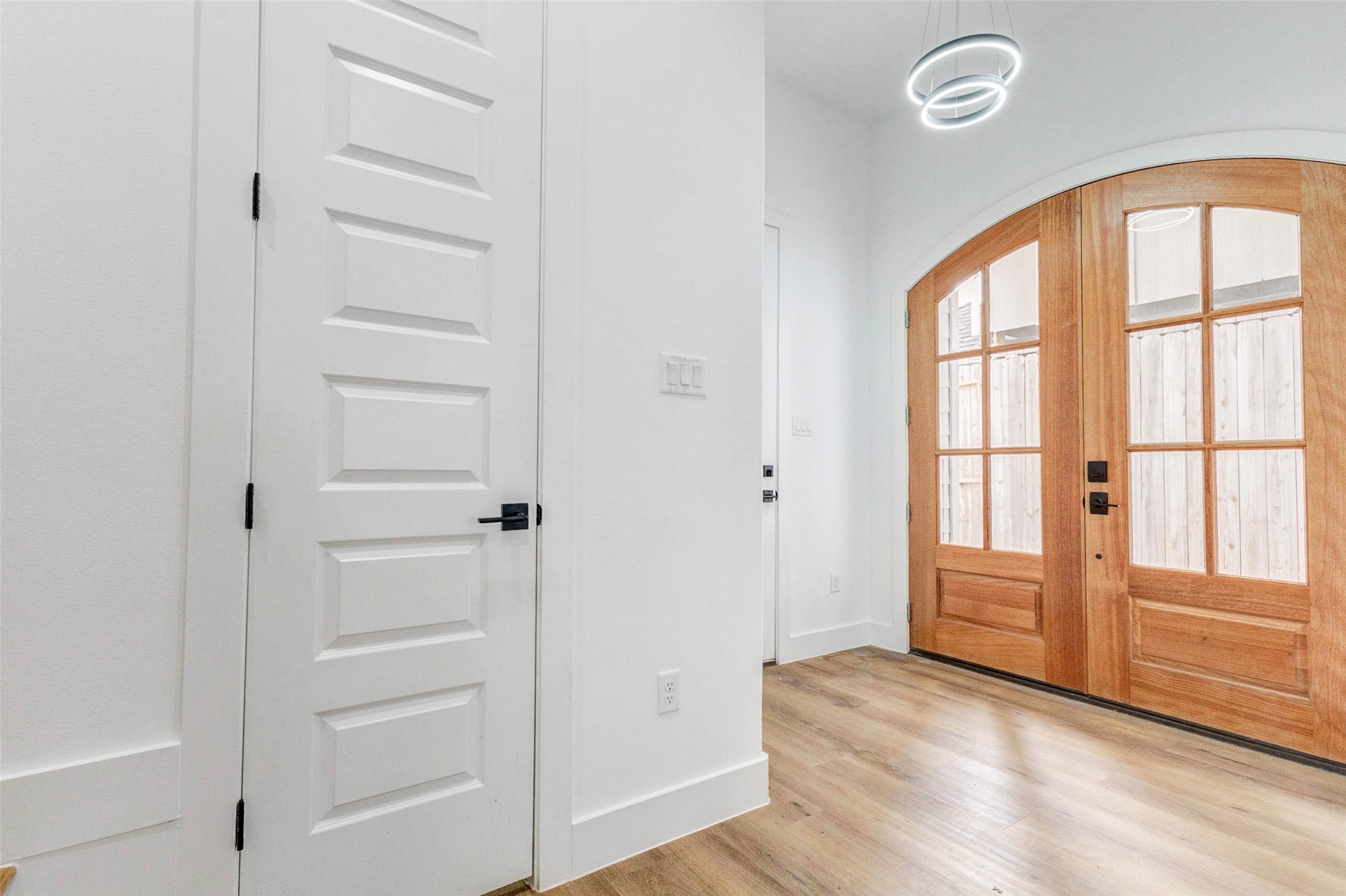2118 Live Oak Street, Unit B Houston, TX 77003 - Photo 5 of 50 A bright, modern entry pairs warm wood tones with crisp white walls and clean-lined doors for a balanced, contemporary feel. Subtle lighting and wide-plank flooring keep the space feeling open, intentional, and quietly polished.