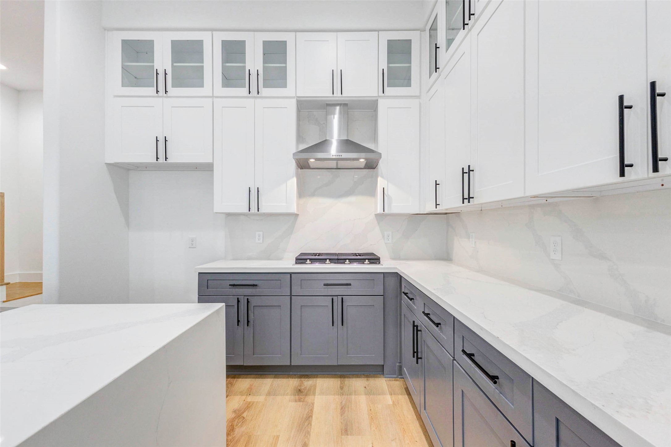 2118 Live Oak Street, Unit B Houston, TX 77003 - Photo 10 of 50 A clean, modern kitchen with plenty of counter space and a simple two-tone cabinet look. The layout feels practical and open, with crisp finishes that keep everything bright and easy to use.