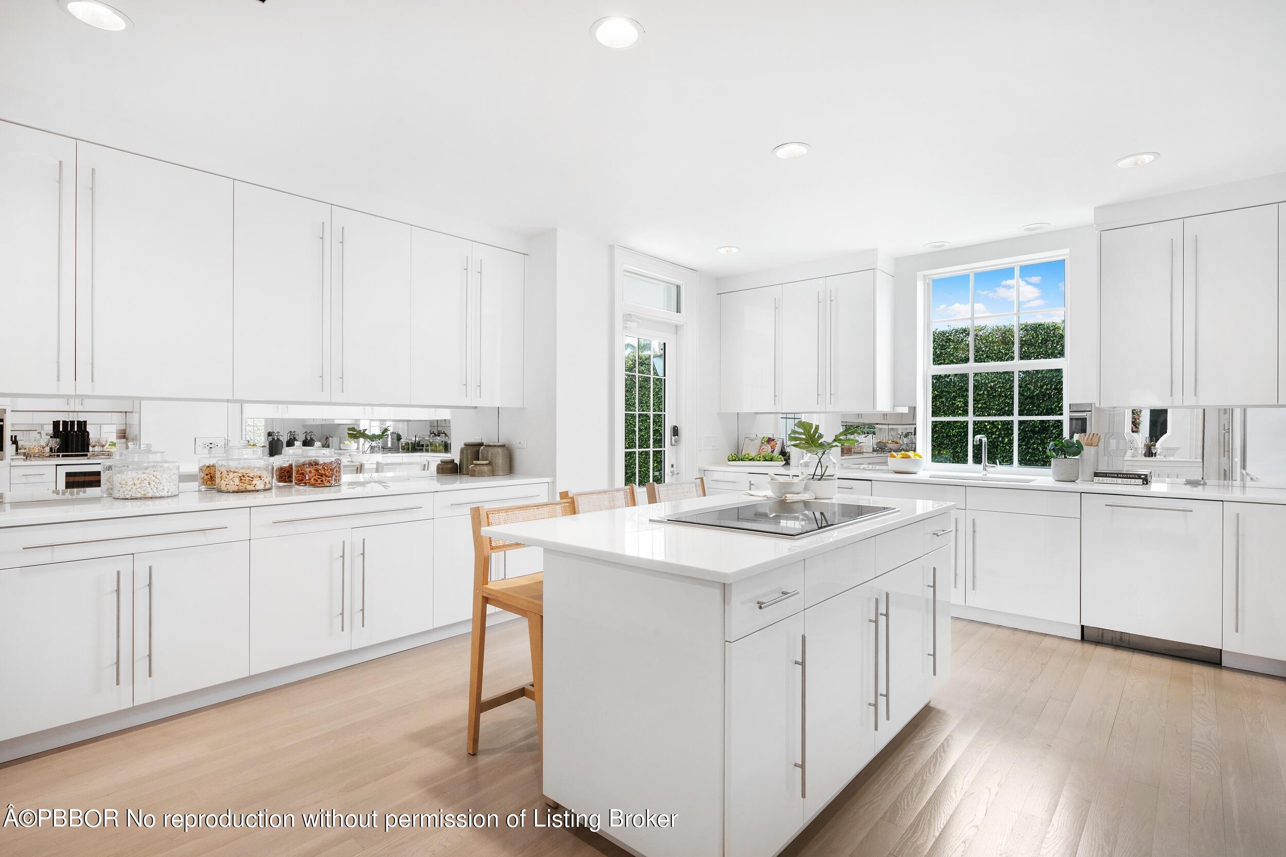 301 Polmer Park Road Palm Beach, FL 33480 - Photo 12 of 43 a kitchen with white cabinets and white appliances