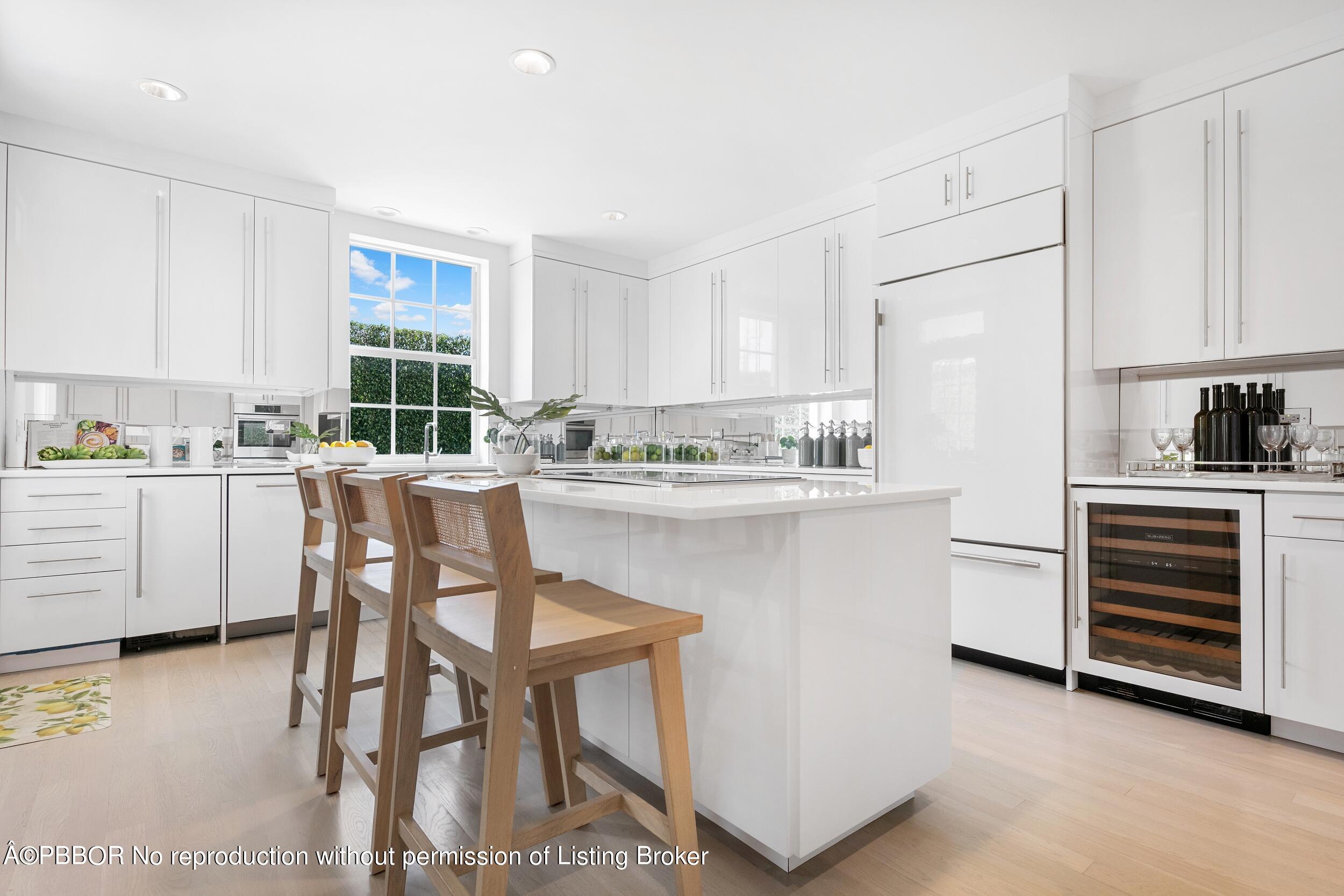 301 Polmer Park Road Palm Beach, FL 33480 - Photo 14 of 43 a kitchen with a table chairs refrigerator and cabinets