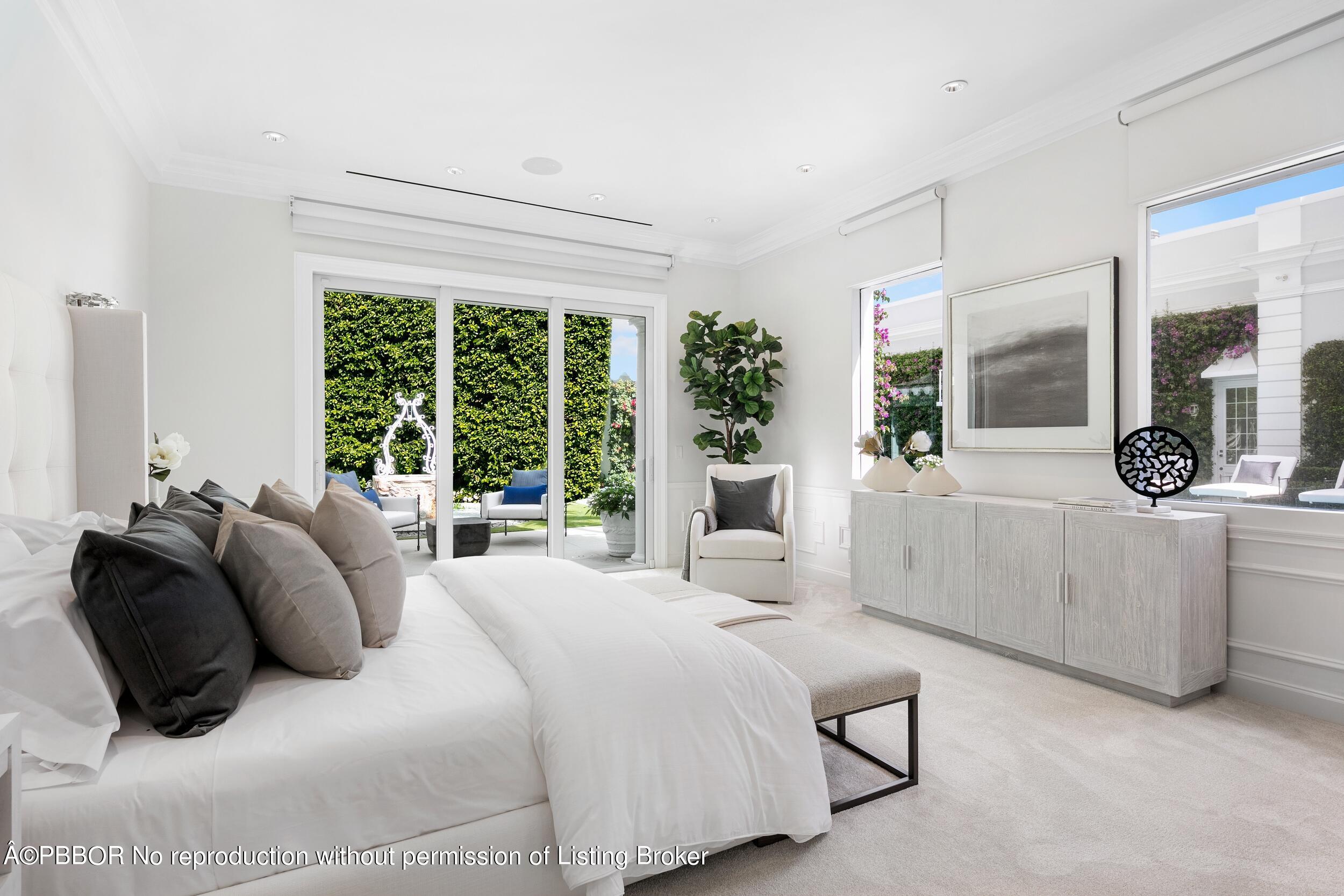 301 Polmer Park Road Palm Beach, FL 33480 - Photo 22 of 43 a bedroom with a bed a large window and potted plant on the dresser
