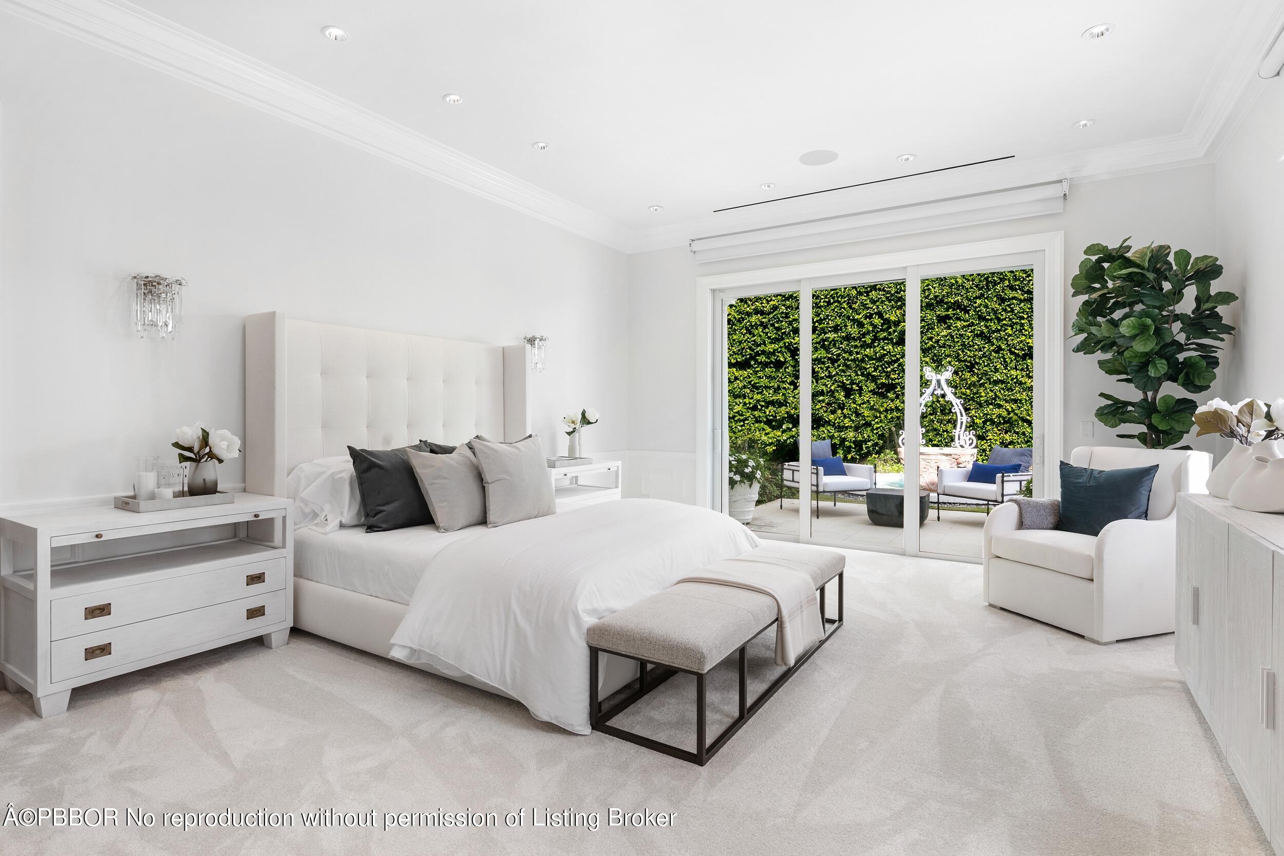 301 Polmer Park Road Palm Beach, FL 33480 - Photo 23 of 43 a spacious bedroom with a bed and a large window