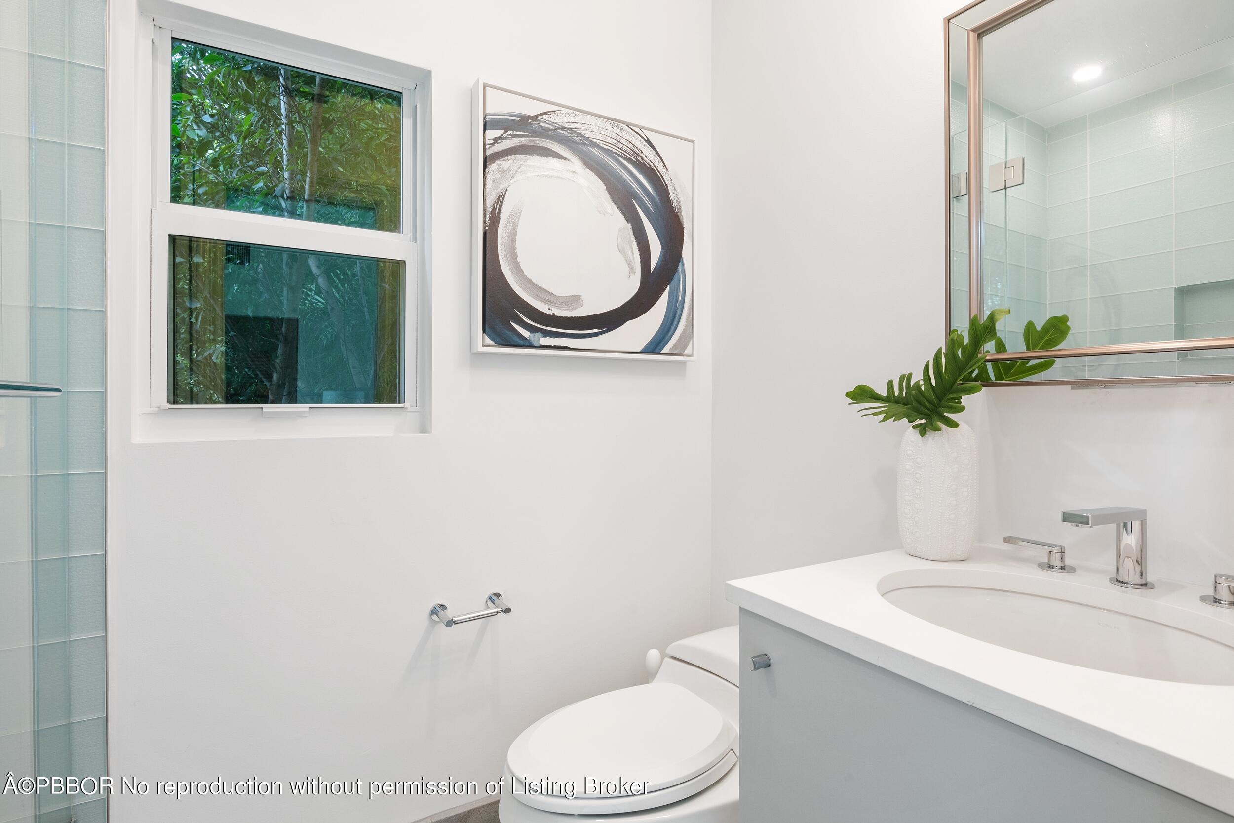 301 Polmer Park Road Palm Beach, FL 33480 - Photo 30 of 43 a bathroom with a toilet a sink and a mirror