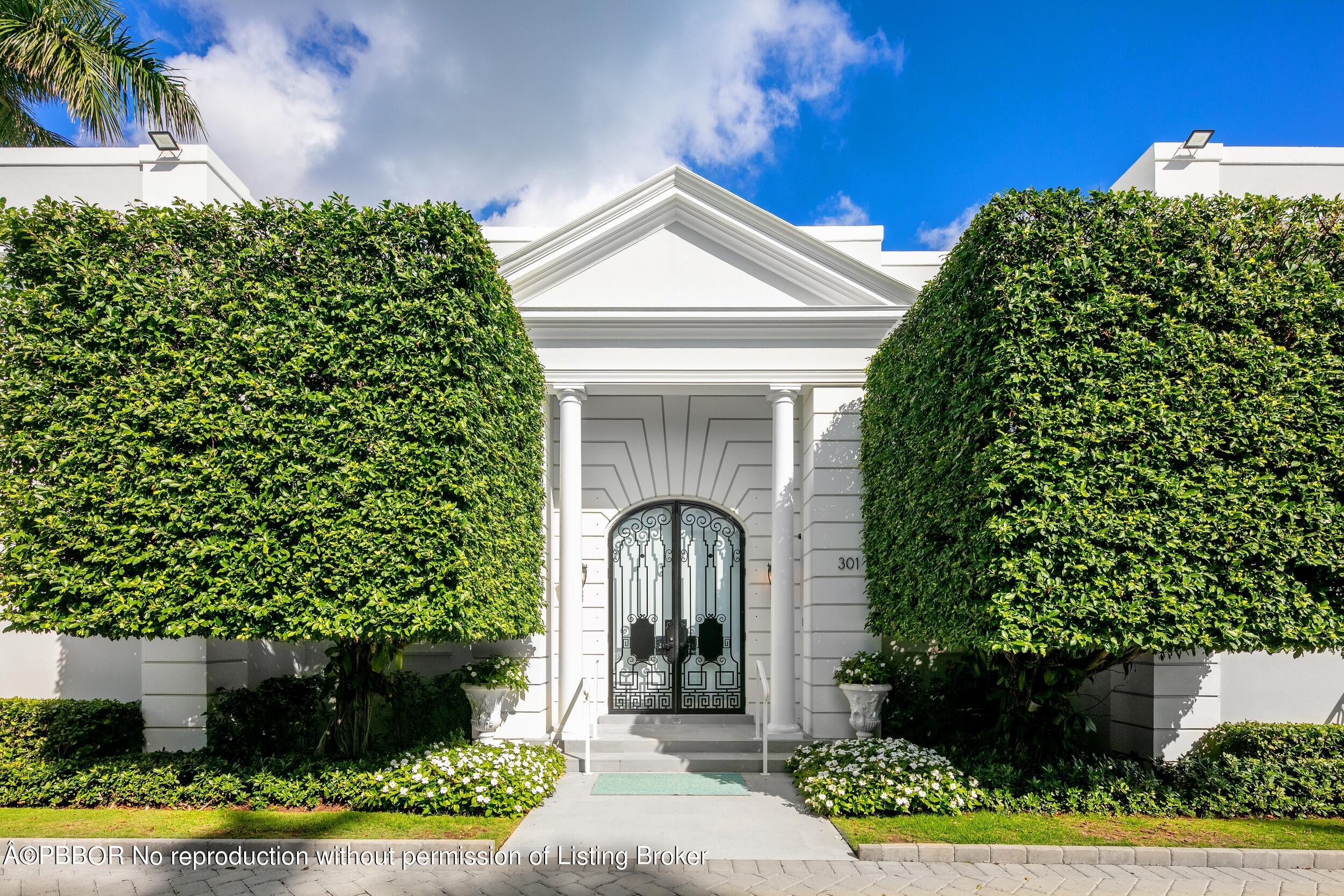 301 Polmer Park Road Palm Beach, FL 33480 - Photo 3 of 43 a front view of a house with a garden