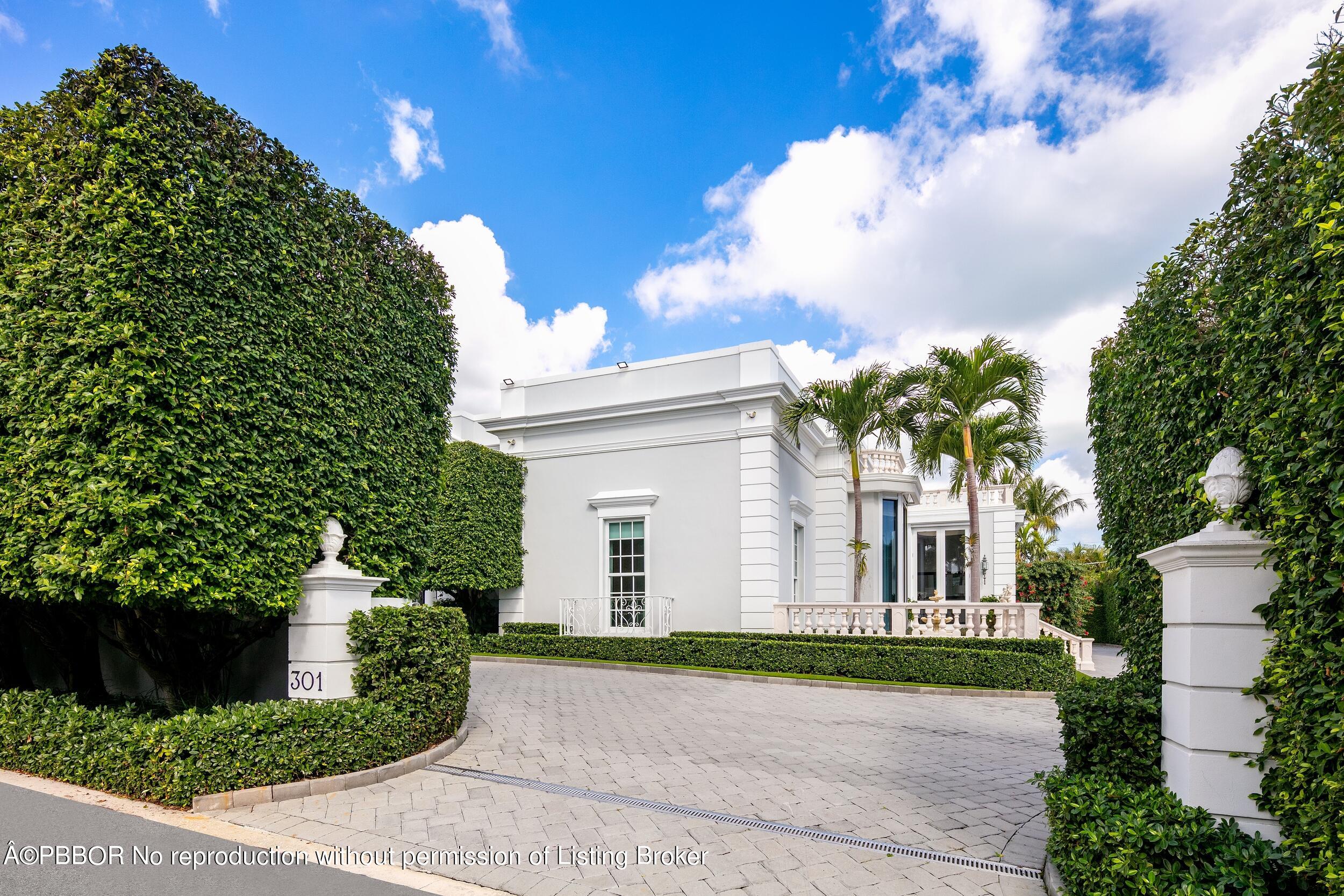 301 Polmer Park Road Palm Beach, FL 33480 - Photo 38 of 43 a front view of a house with a yard and garage