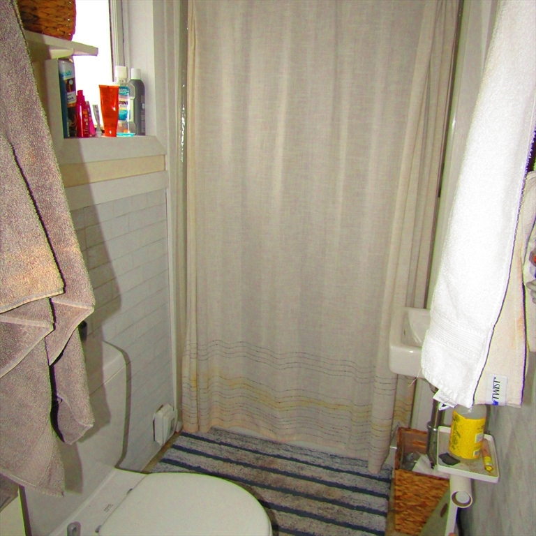 102 Vernon Street, Unit 2 Northampton, MA 01060 - Photo 7 of 7 a bathroom with a sink and a shower curtain