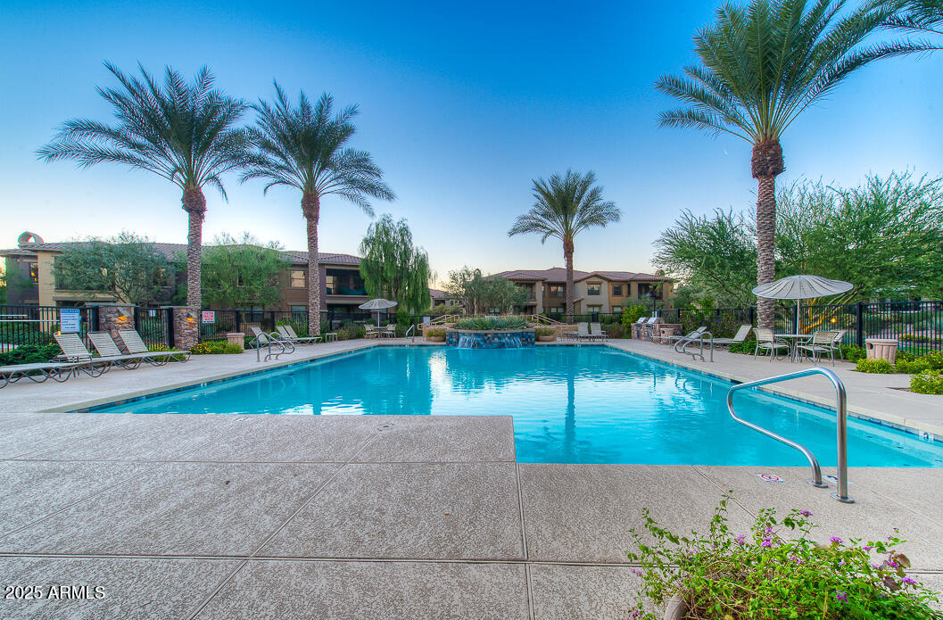 a view of swimming pool with a table and chairs