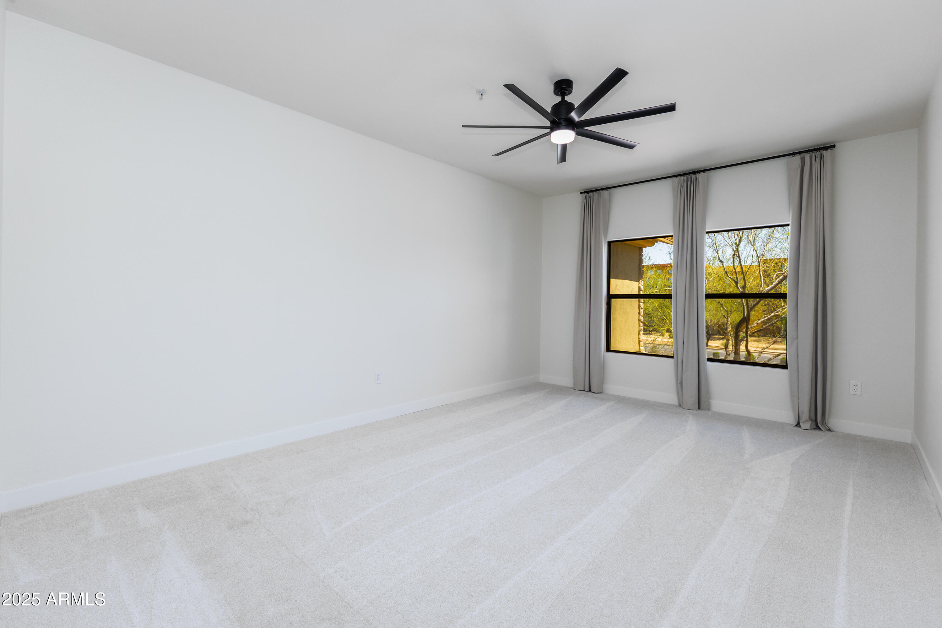 21320 North 56th Street, Unit 2001 Phoenix, AZ 85054 - Photo 11 of 45 an empty room with windows and ceiling fan