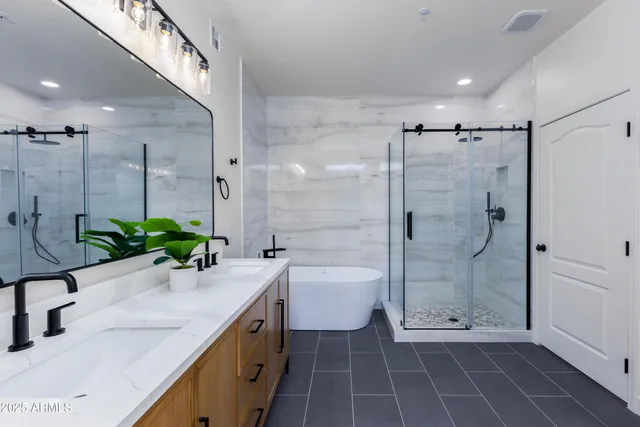 a bathroom with a granite countertop sink a toilet and shower