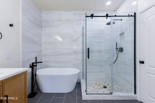 a bathroom with a bathtub and shower