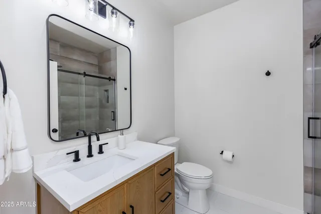 a bathroom with a sink toilet and mirror