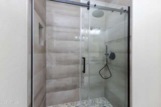 a bathroom with a glass shower door