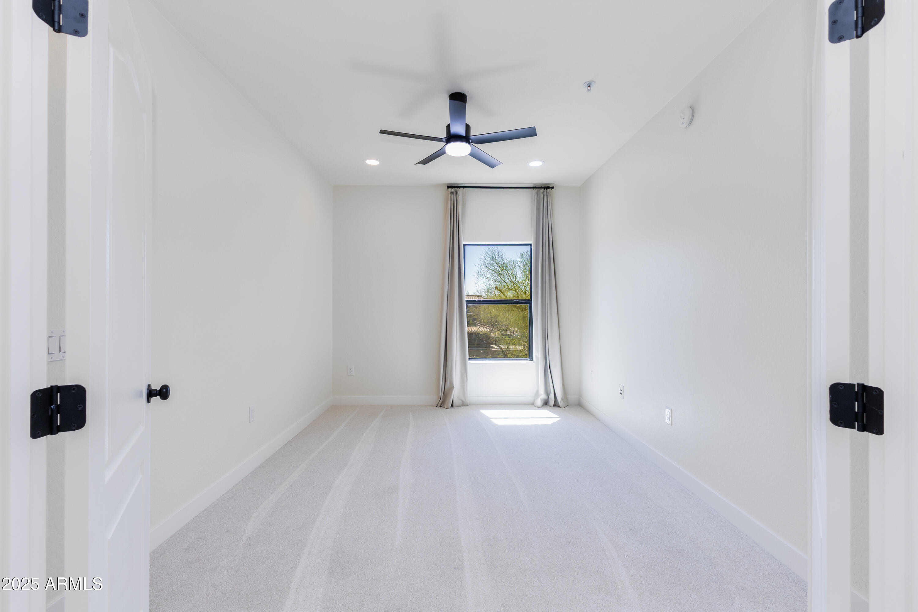21320 North 56th Street, Unit 2001 Phoenix, AZ 85054 - Photo 19 of 45 an empty room with a window and a ceiling fan