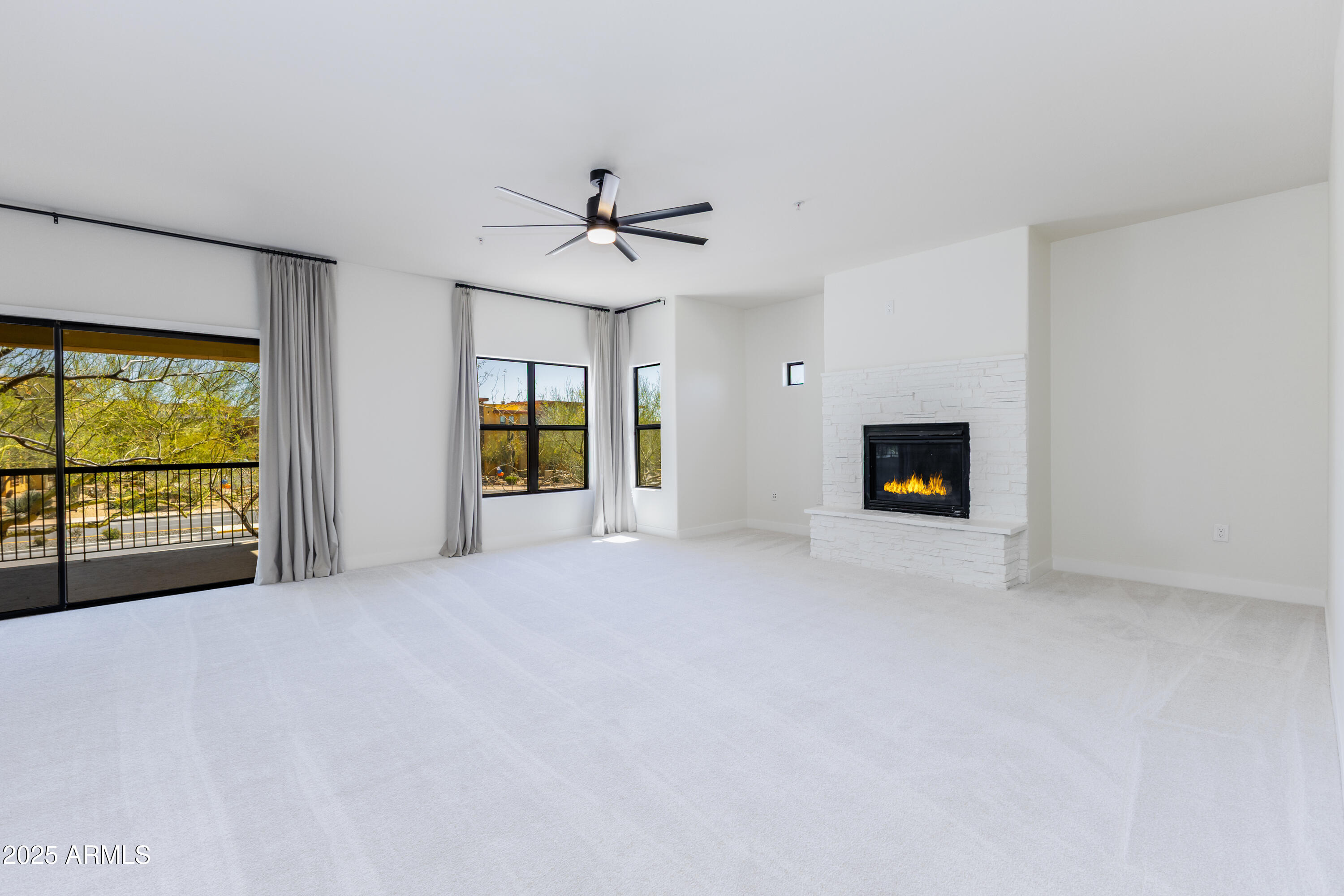 21320 North 56th Street, Unit 2001 Phoenix, AZ 85054 - Photo 5 of 45 a view of empty room with a fireplace and window