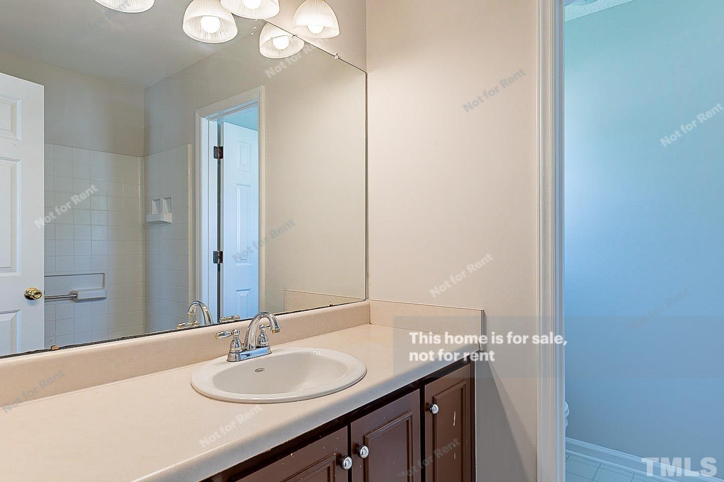 565 Darby Glen Lane Durham, NC 27713 - Photo 12 of 18 a bathroom with a granite countertop sink and a mirror