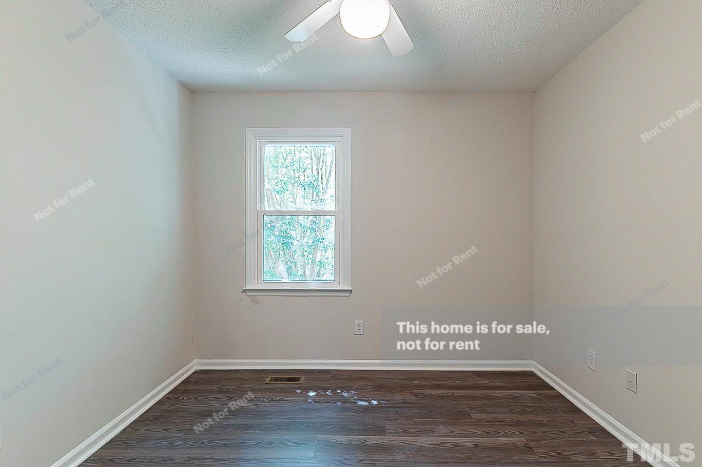 565 Darby Glen Lane Durham, NC 27713 - Photo 14 of 18 an empty room with wooden floor and windows